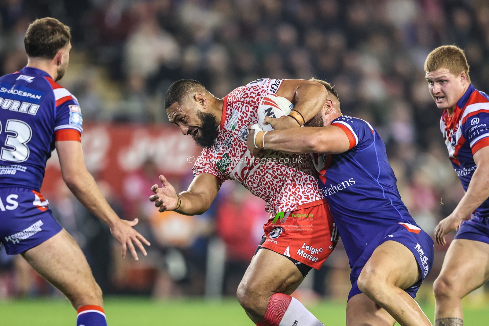 Isaac Liu of Leigh Leopards is tackled during the Betfred Super League play-off Eliminator 1 match Leigh Leopards vs Wakefield Trinity at Progress With Unity Stadium, Leigh, United Kingdom, 26th September 2025

(Photo by Alfie Cosgrove/News Images)