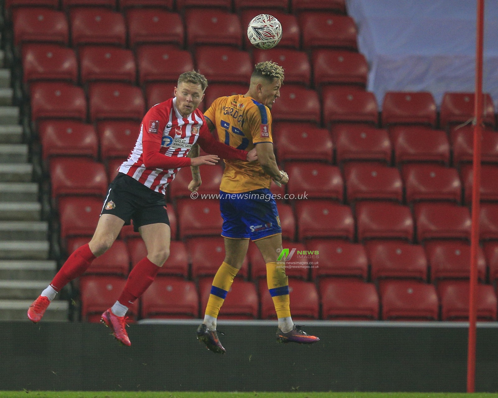 Aiden O'Brien #10 of Sunderland in an aerial challenge with Kellan Gordon #12 of Mansfield Town