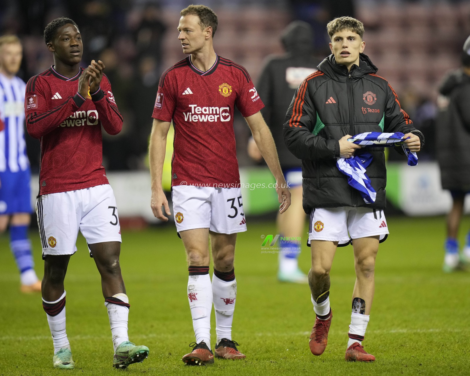 Kobbie Mainoo of Manchester United, Jonny Evans of Manchester United and Alejandro Garnacho of Manchester United salutes the fans after the Emirates FA Cup Third Round match Wigan Athletic vs Manchester United at DW Stadium, Wigan, United Kingdom, 8th January 2024

(Photo by Steve Flynn/News Images)