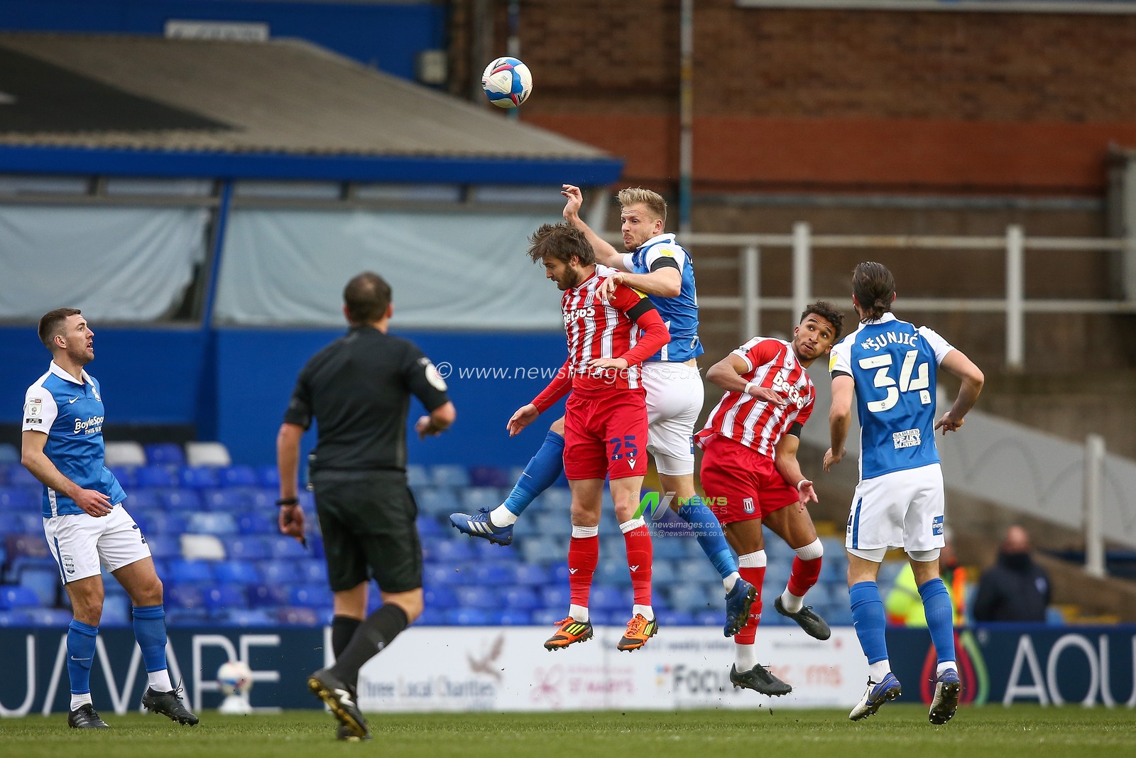 Marc Roberts #4 of Birmingham City and Nick Powell #25 of Stoke City compete for the aerial ball