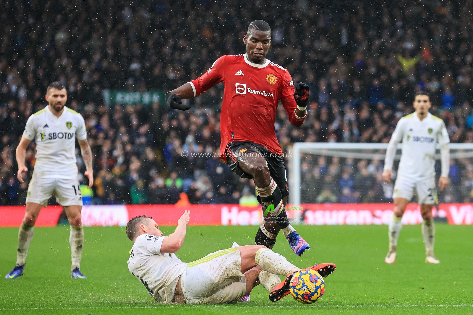 Paul Pogba #6 of Manchester United is tackled by Adam Forshaw #4 of Leeds United