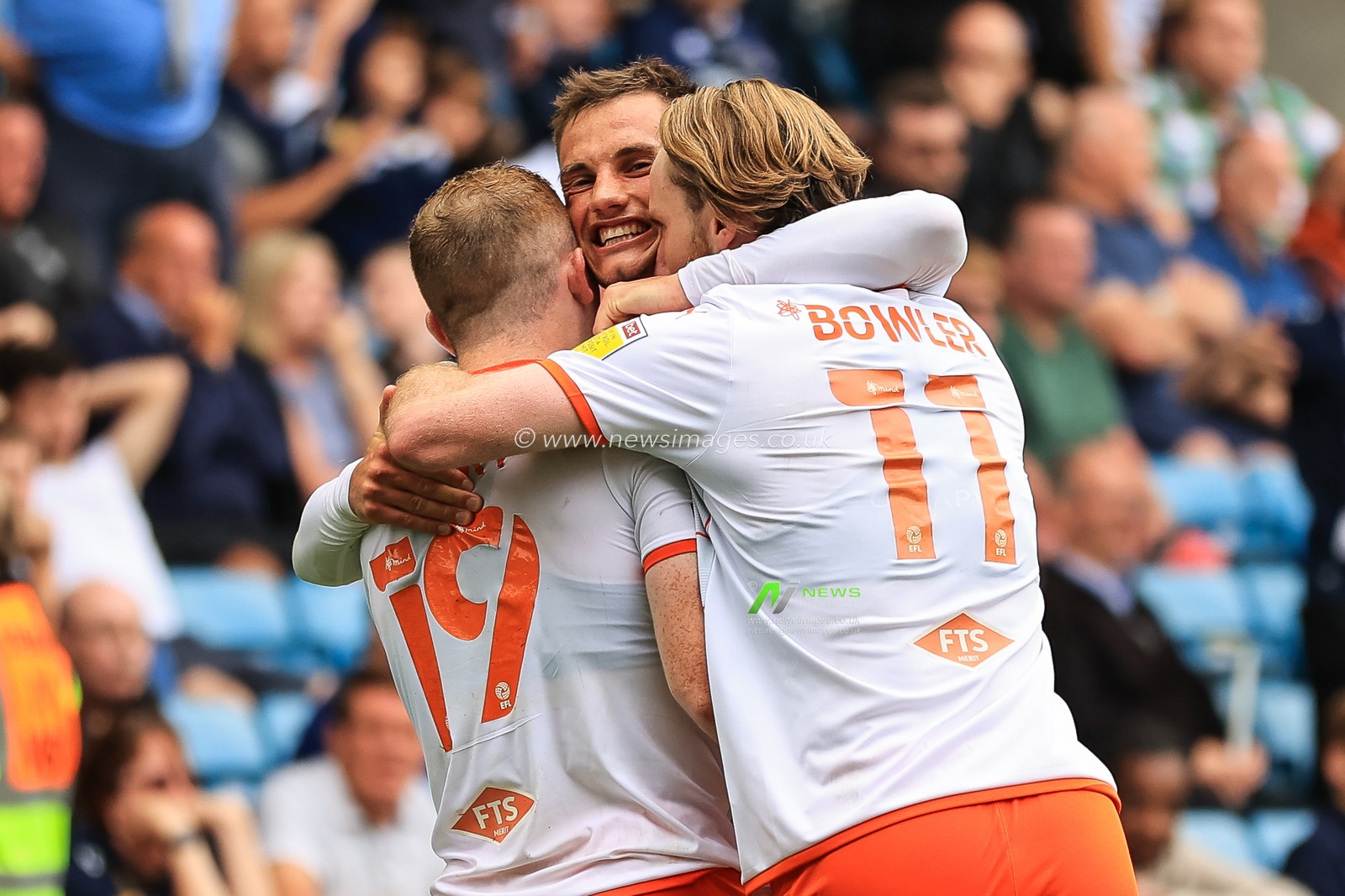 Shayne Lavery #19 of Blackpool celebrates his goal with team mates.