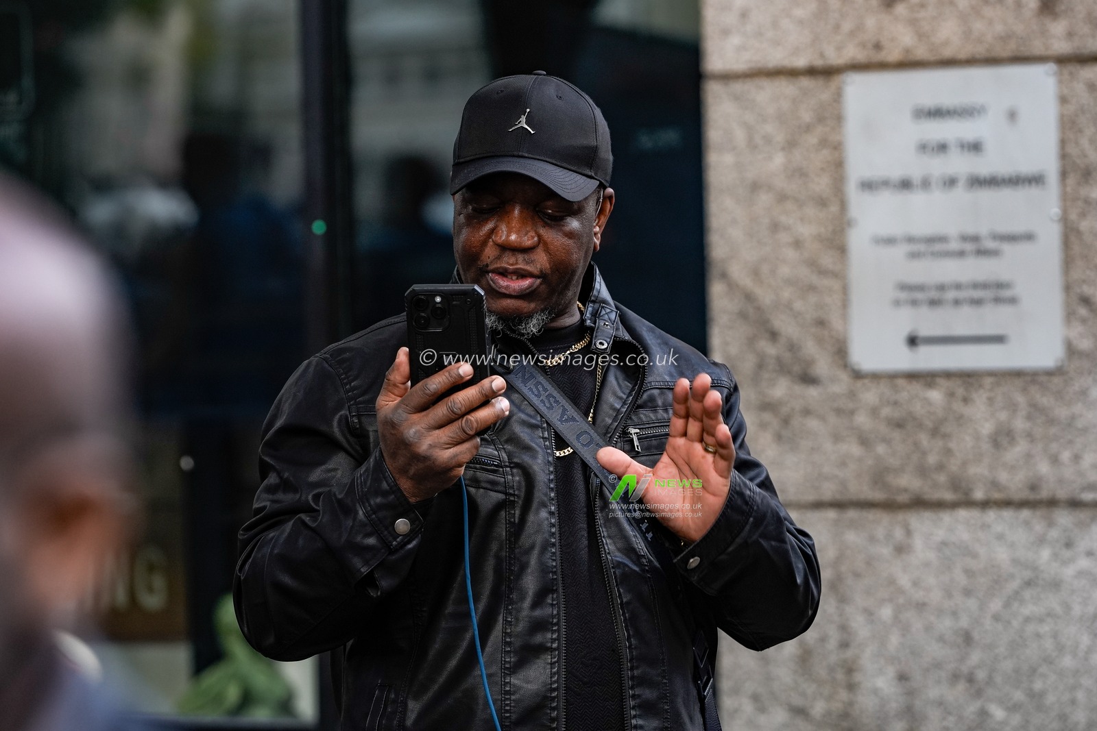 Shepherd Yuda steams live as UK-based Zimbabweans gather outside the Zimbabwe Embassy in London on 18 April 2026 to protest the Constitution of Zimbabwe Amendment (No. 3) Bill, which critics say would extend President Mnangagwa’s rule until 2030 and strip citizens of the direct vote for president.

(Photo by Maynard Manyowa/News Images)