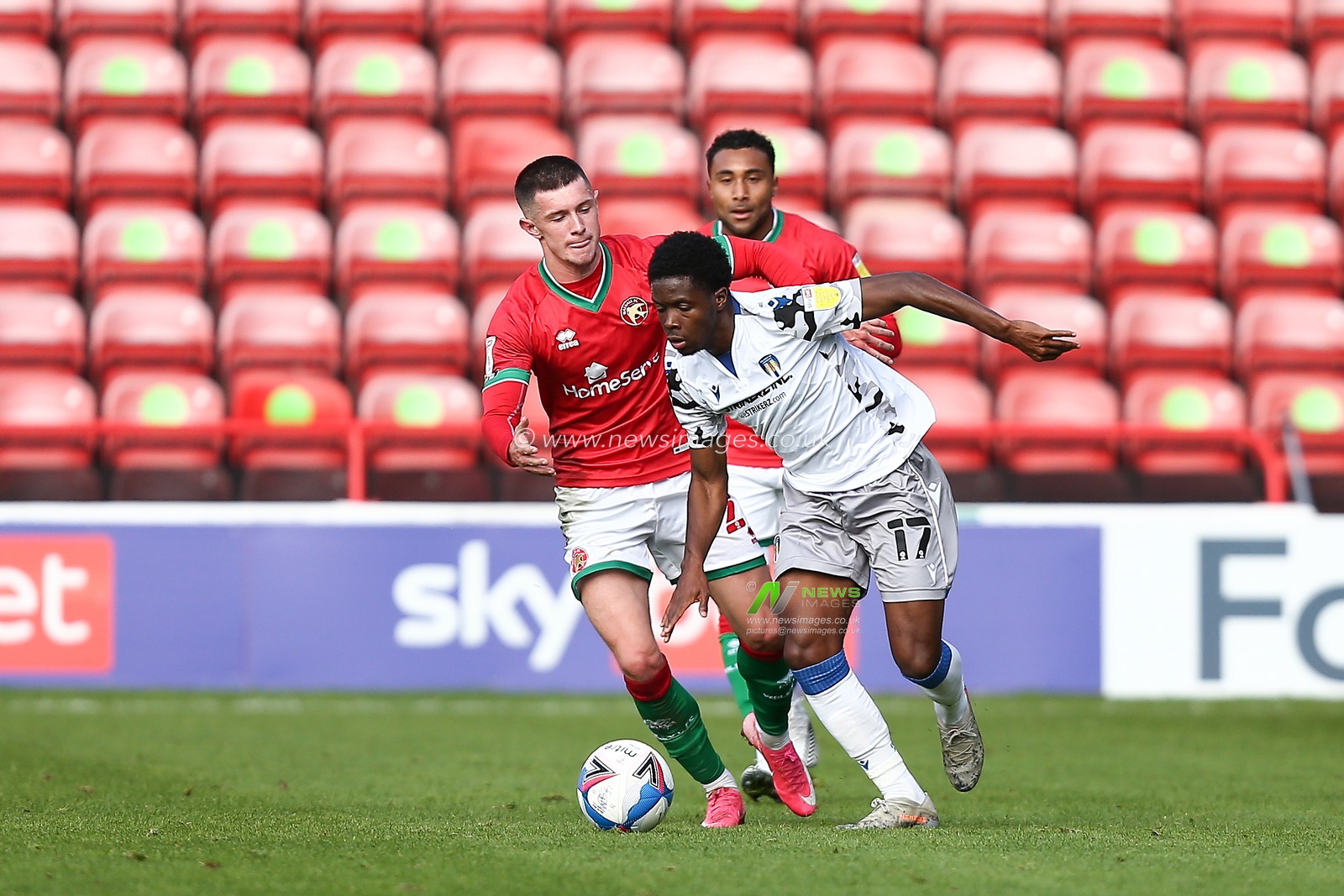 Miquel Scarlett (17) of Colchester United is tackled by Rory Holden (22) of Walsall