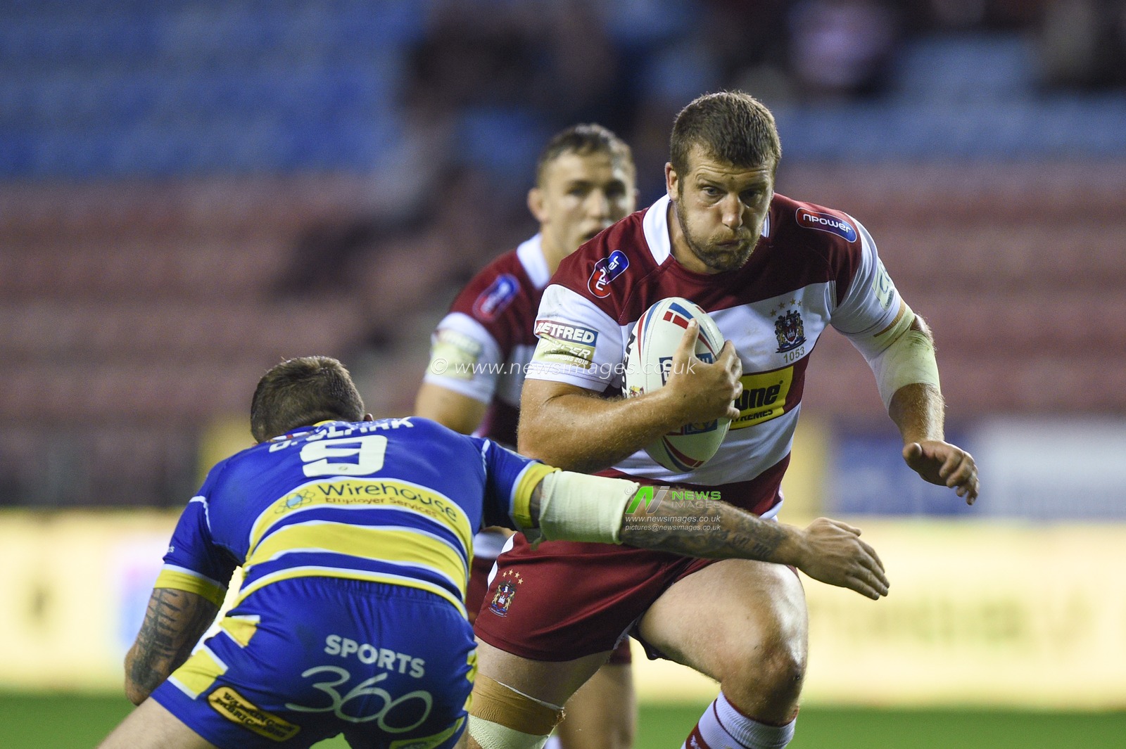 16th August 2019 , DW Stadium, Wigan, England;  Betfred Super League, Round 26, Wigan Warriors vs Warrington Wolves ; Tony Clubb of Wigan Warriors is tackled by Daryl Clark of Warrington Wolves 

Credit: Richard Long/News Images