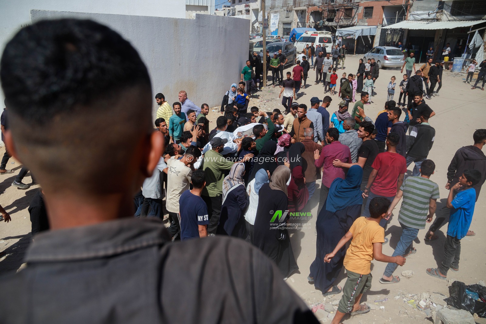 Families bid farewell to their sons killed in today's Israeli massacre at the Al-Wehda Street market in western Gaza City, which left 40 dead and a large number of injuries, including children and women.(Photo: Mohammed Skaik/News Images)