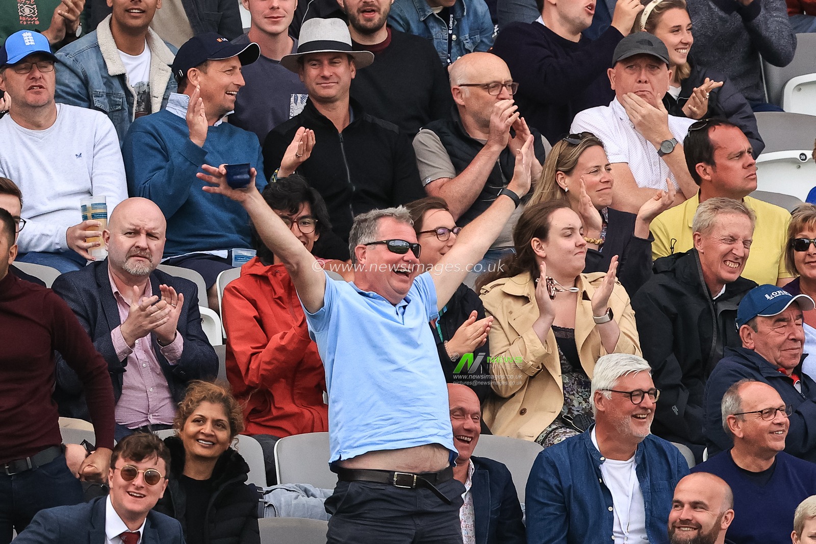 An England fan celebrates a four from Joe Root of England