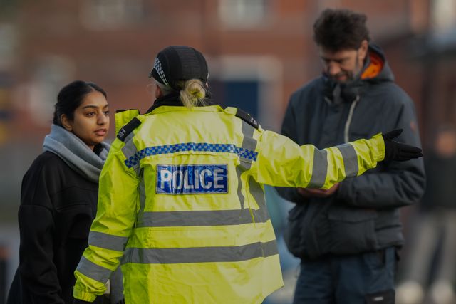 A police officer speaks to members of the public outside an address on Cambridge Street, Derby, during a Major Explosives Incident in Derby that began on Thursday December 4 when police executed a warrant at an address on Vulcan Street, Derby, that saw two men arrested on suspicion of explosives offences and 200 homes evacuated (Maynard Manyowa / News Images)