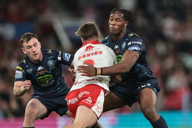 Tom Davies of Hull KR is tackled by Junior Nsemba of Wigan Warriors during the 2025 Betfred Super League Grand Final Hull KR v Wigan Warriors at Old Trafford, Manchester, United Kingdom, 11th October 2025

(Photo by Mark Cosgrove/News Images)