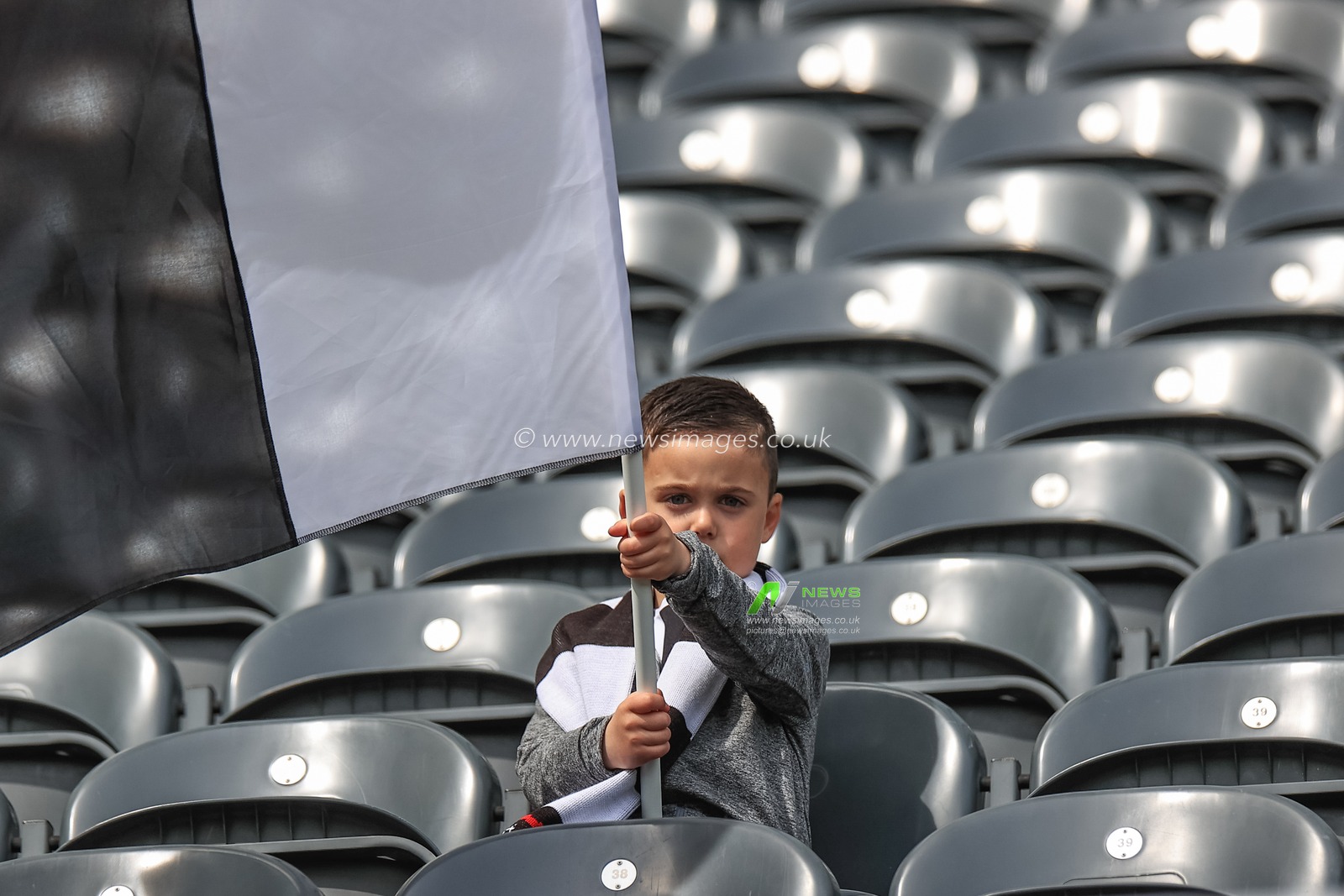 A young Newcastle fan flys a flag