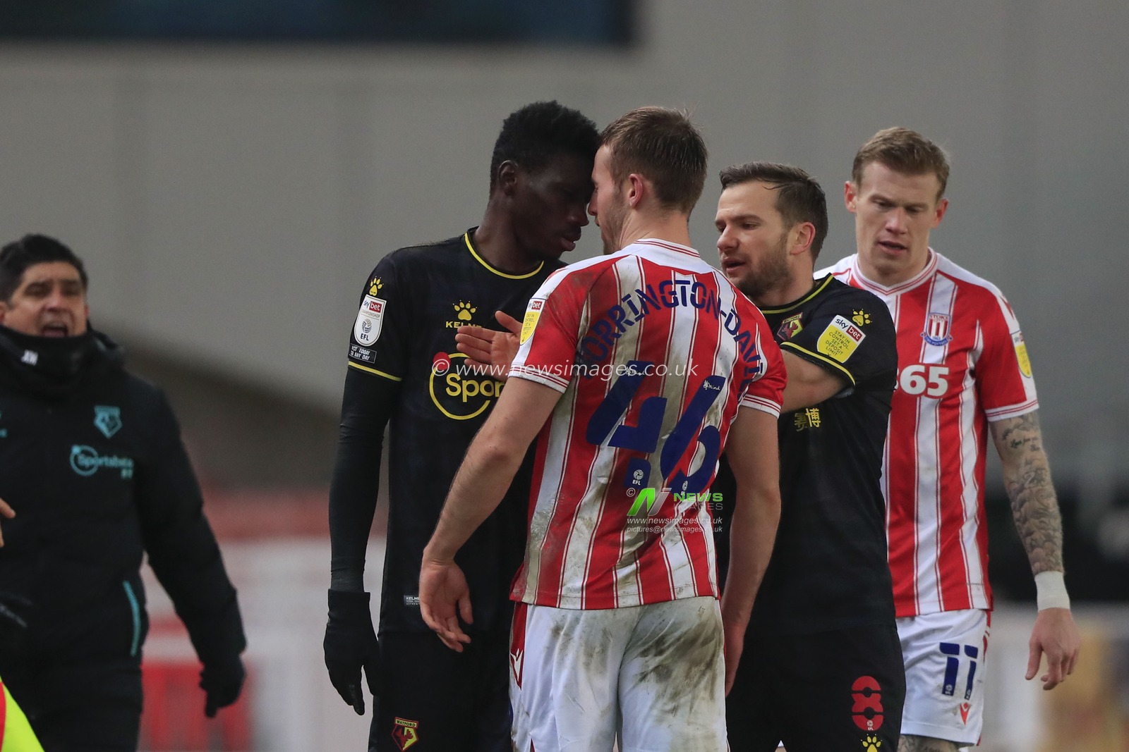 Ismaila Sarr #23 of Watford and Rhys Norrington-Davies #46 of Stoke City confront each other