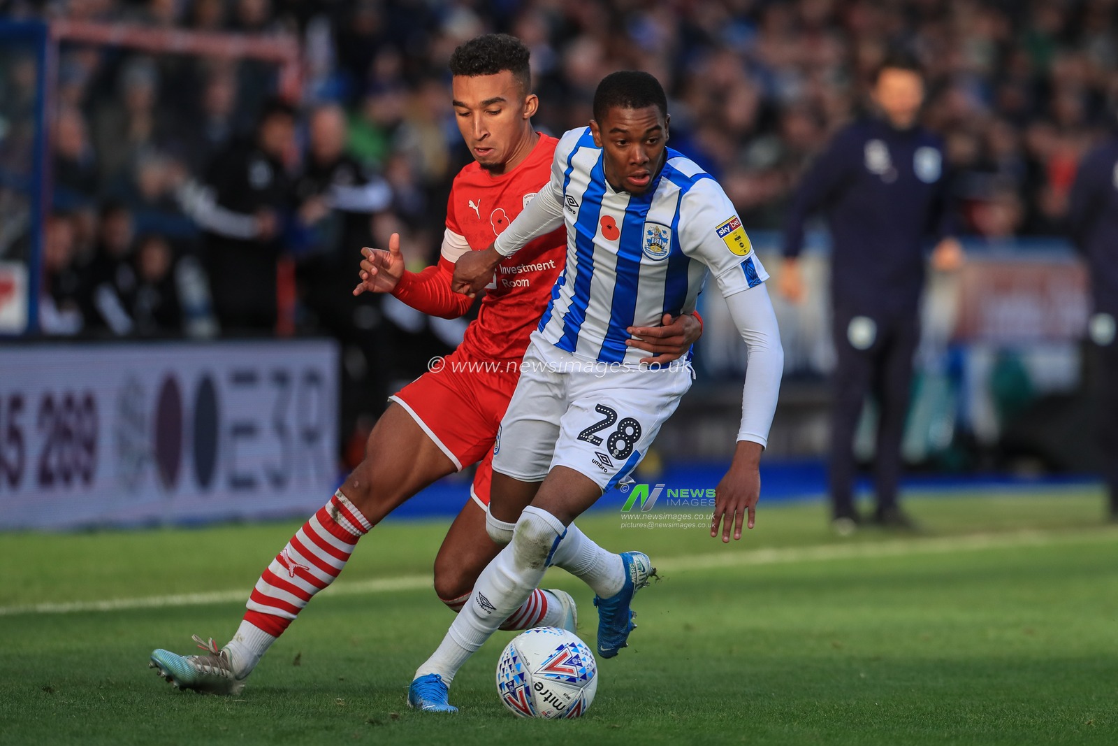 26th October 2019, John Smith's Stadium, Huddersfield, England; Sky Bet Championship, Huddersfield Town v Barnsley : Jaden Brown (28) of Huddersfield Town is held back by Jacob Brown (7) of Barnsley 

Credit: Mark Cosgrove/News Images