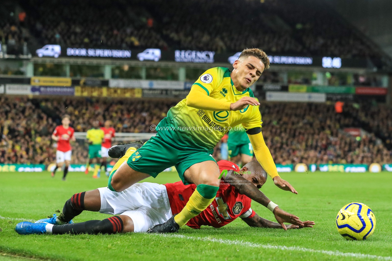 27th October 2019, Carrow Road, Norwich, England; Premier League, Norwich City v Manchester United : Ashley Young (18) of Manchester United fouls Max Aarons (2) of Norwich City and receives a yellow card 

Credit: Mark Cosgrove/News Images