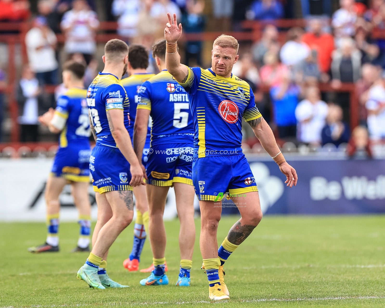 Oliver Holmes #12 of Warrington Wolves wakes to the traveling fans