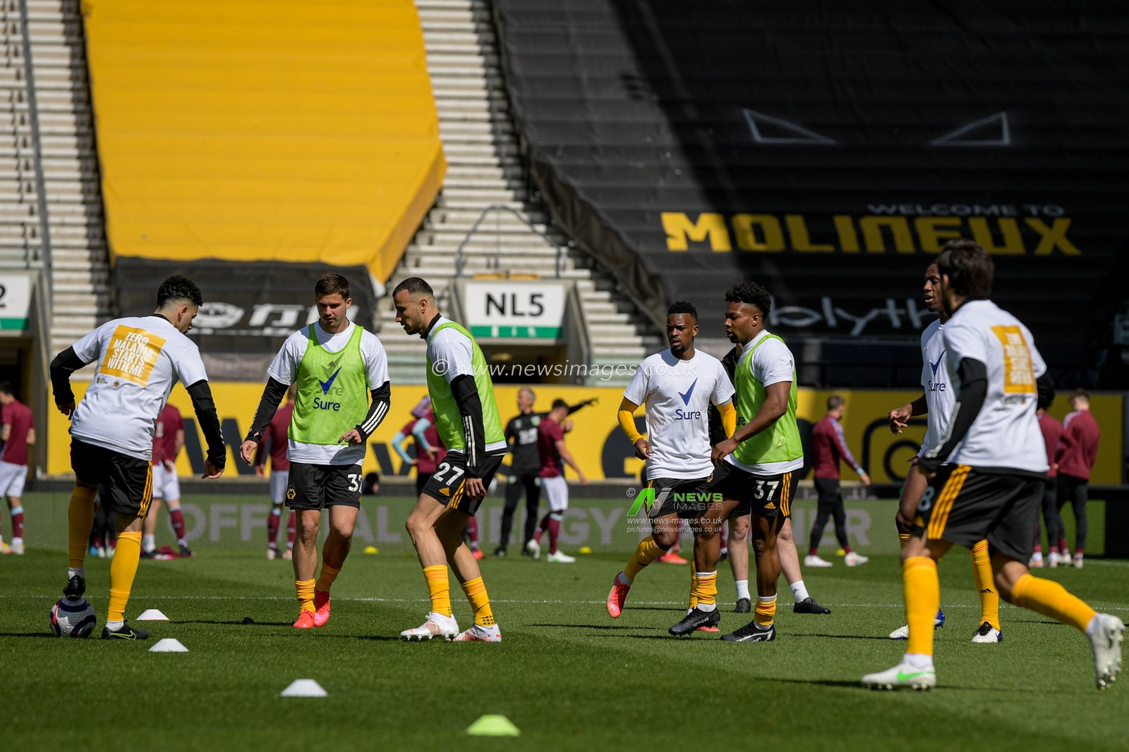 The Wolverhampton Wanderers players warm up on the pitch before the game