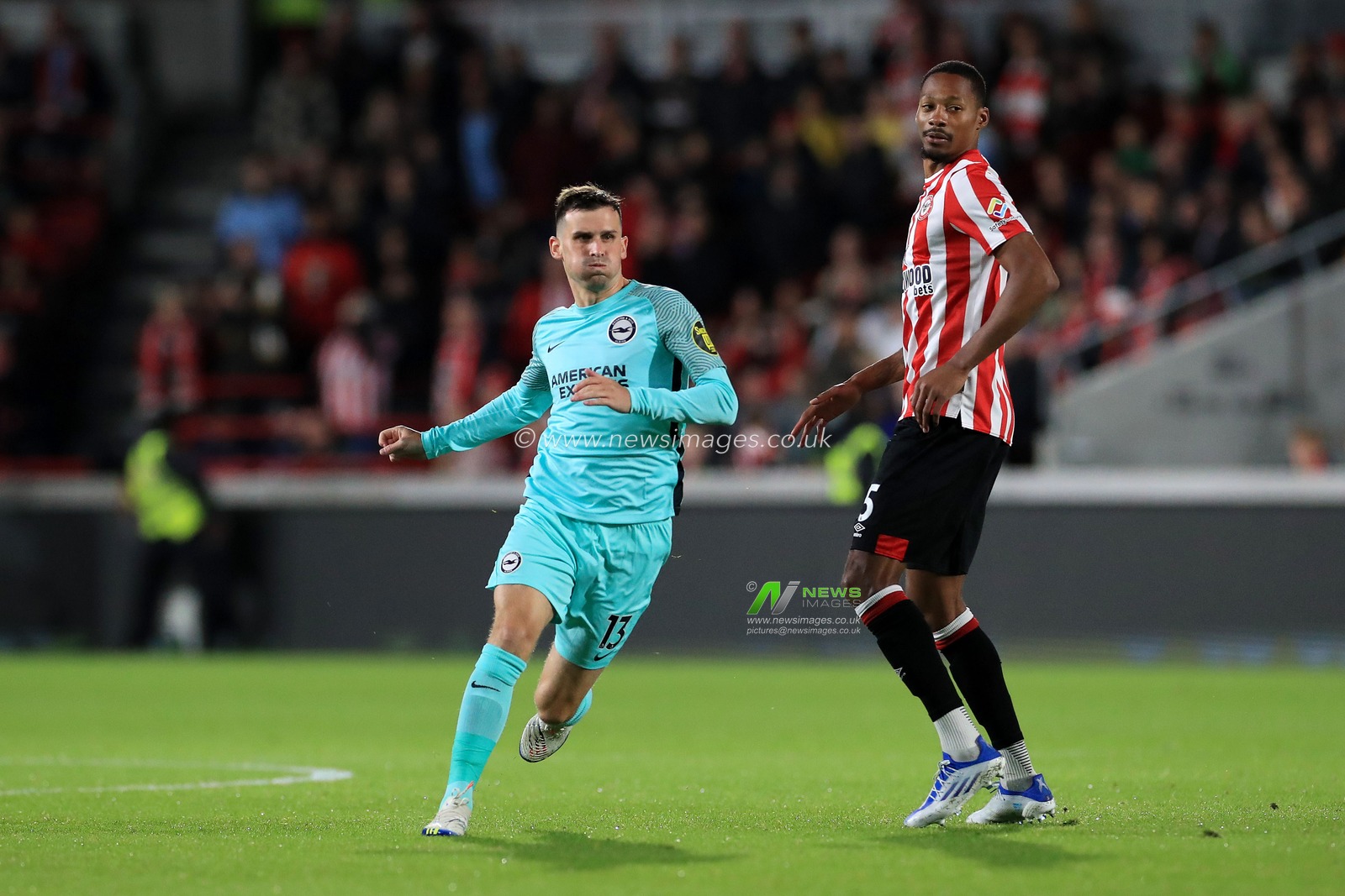Pascal GroÃŸ #13 of Brighton & Hove Albion and Ethan Pinnock #5 of Brentford during the Premier League match Brentford vs Brighton and Hove Albion at Brentford Community Stadium, London, United Kingdom, 14th October 2022

(Photo by Carlton Myrie/News Images)