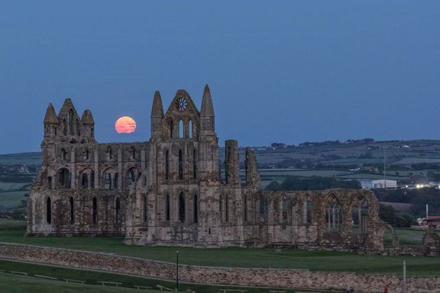 Rare Strawberry Moon rises over Whitby Abbey