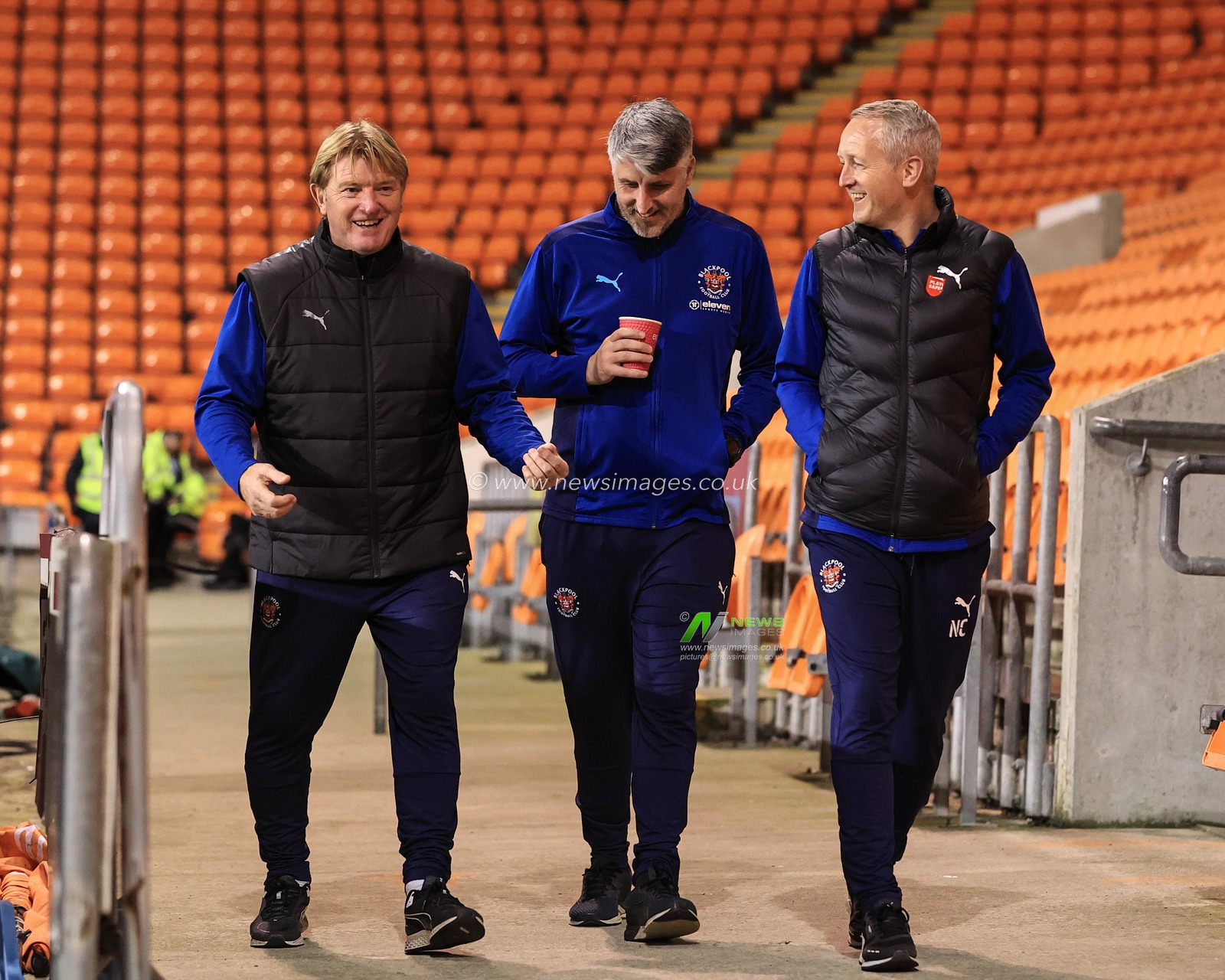Stuart McCall Assistant head coach of Blackpool reciting footballing moments with Mike Garrity coach of Blackpool and Neil Critchley Head Coach of Blackpool as they arrive at Bloomfield Road