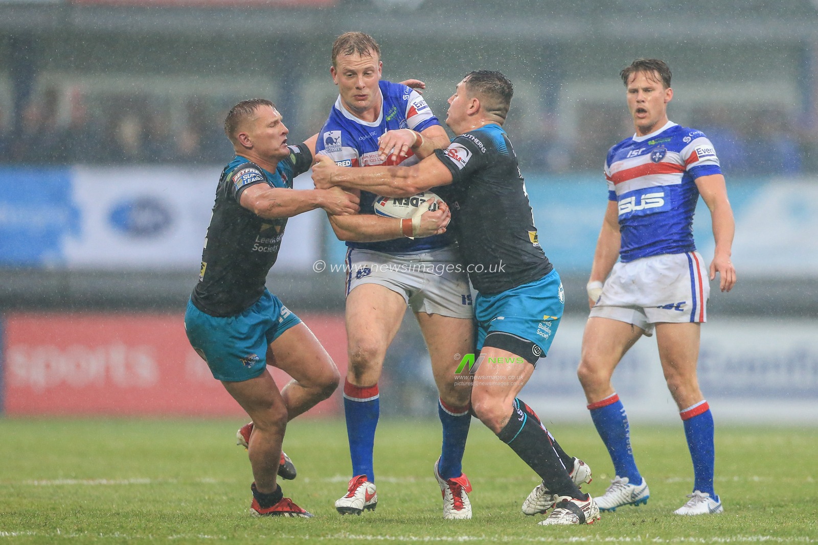 7th June 2019 , Mobile Rocket Stadium, Wakefield, England;  Betfred Super League, Round 17, Wakefield Trinity vs Leeds Rhinos ; George King (22) of Wakefield Trinity is tackled by Brad Dwyer (14) of Leeds Rhinos and Trent Merrin (11) of Leeds Rhinos 


 

Credit: Mark Cosgrove/News Images