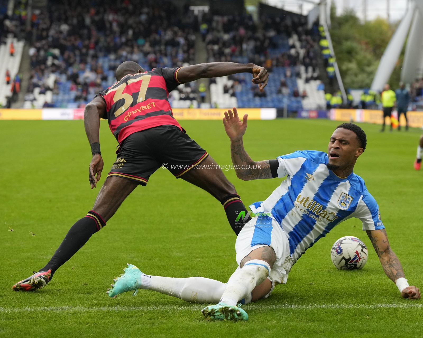 Albert Adomah #37 of Queens Park Rangers fouls Delano Burgzorg #7 of Huddersfield Town during the Sky Bet Championship match Huddersfield Town vs Queens Park Rangers at John Smith's Stadium, Huddersfield, United Kingdom, 21st October 2023

(Photo by Steve Flynn/News Images)