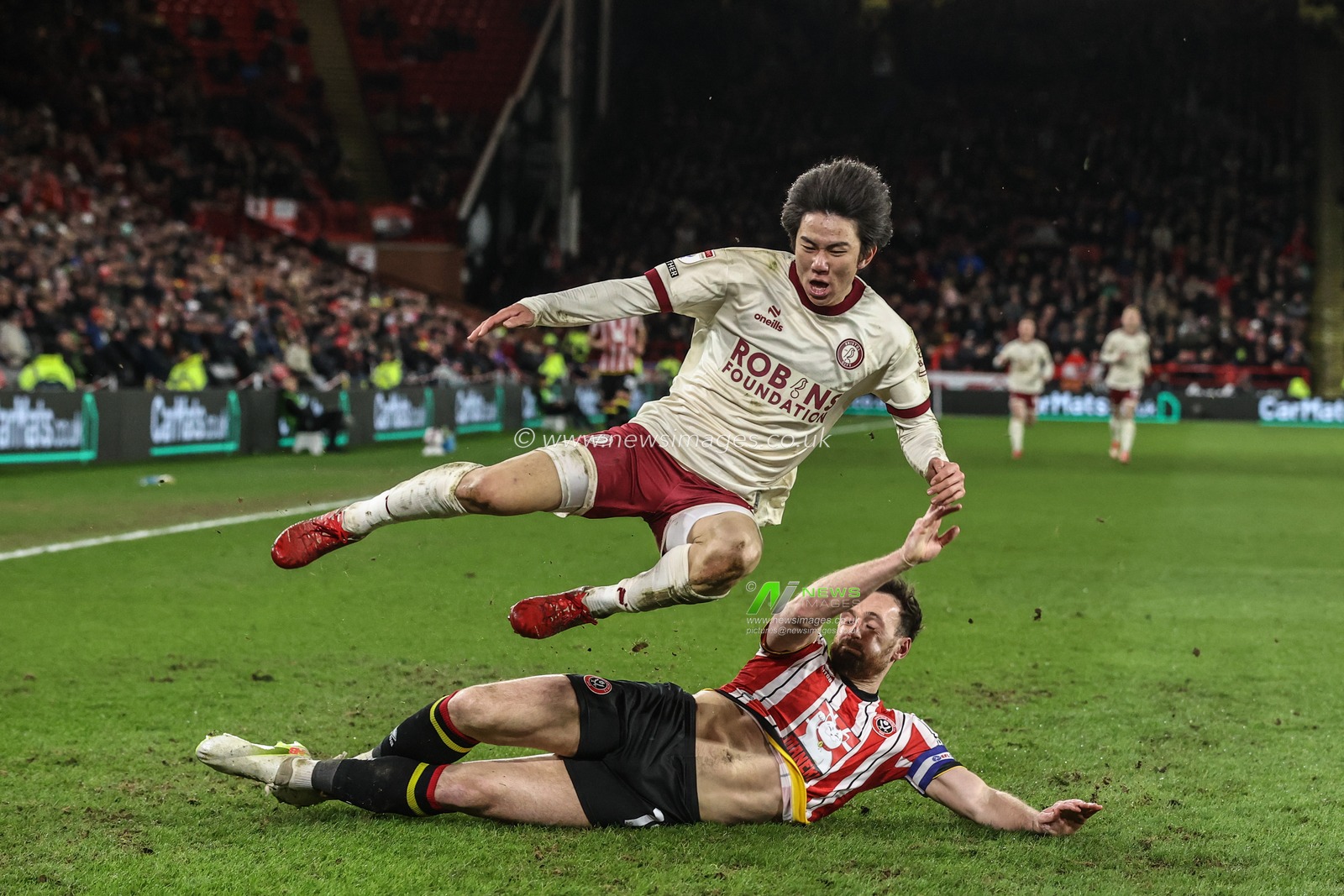 Yu Hirakawa of Bristol City is tackled by Jack Robinson of Sheffield United during the Sky Bet Championship match Sheffield United vs Bristol City at Bramall Lane, Sheffield, United Kingdom, 11th March 2025

(Photo by Alfie Cosgrove/News Images)