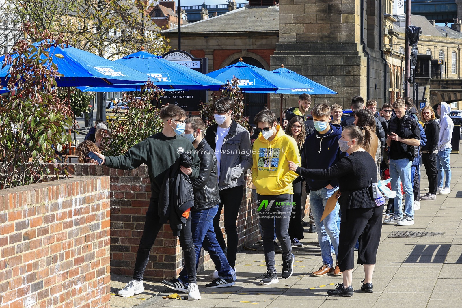 People queue to get in the beer garden at The Quayside pub, Quayside, Newcastle upon Tyne, as pubs are allowed to reopen to serve drinks outdoors as national lockdown restrictions ease