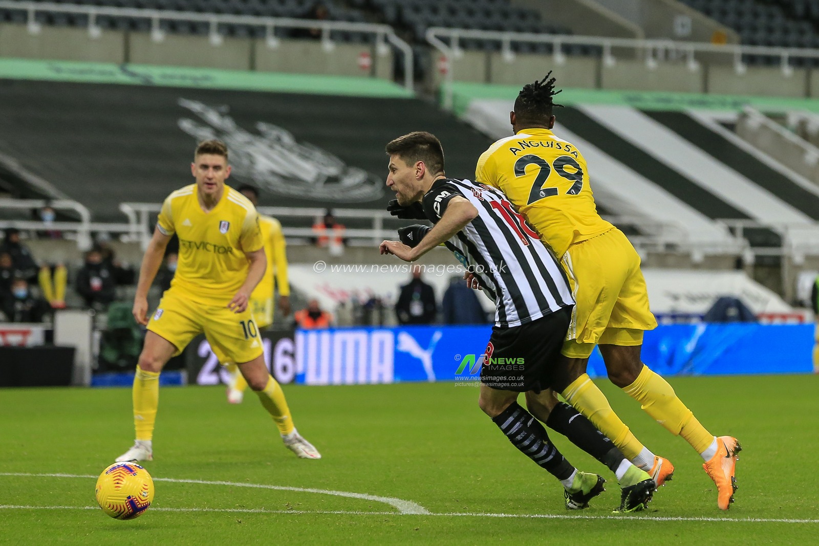 Federico FernÃ¡ndez #18 of Newcastle United fouls AndrÃ©-Frank Zambo Anguissa #29 of Fulham on the edge of the Newcastle United penalty area
