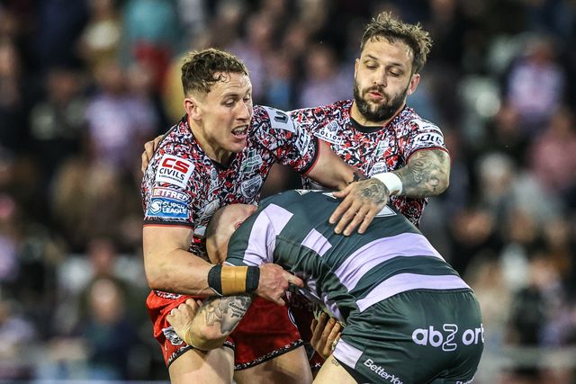 Adam Swift of Huddersfield Giants is tackled by Gareth O'Brien of Leigh Leopards and Adam Cook of Leigh Leopards during the Betfred Super League round 9 match Leigh Leopards vs Huddersfield Giants at Leigh Sports Village, Leigh, United Kingdom on 23 April 2026

(Photo by Alfie Cosgrove/News Images)