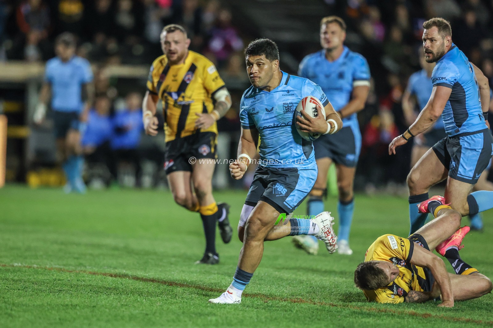 John Asiata of Hull FC is tripped by Alex Mellor of Castleford Tigers during the Betfred Super League Round 6 match Castleford Tigers vs Hull FC at The Mend-A-Hose Jungle, Castleford, United Kingdom, 27th March 2025

(Photo by Alfie Cosgrove/News Images)