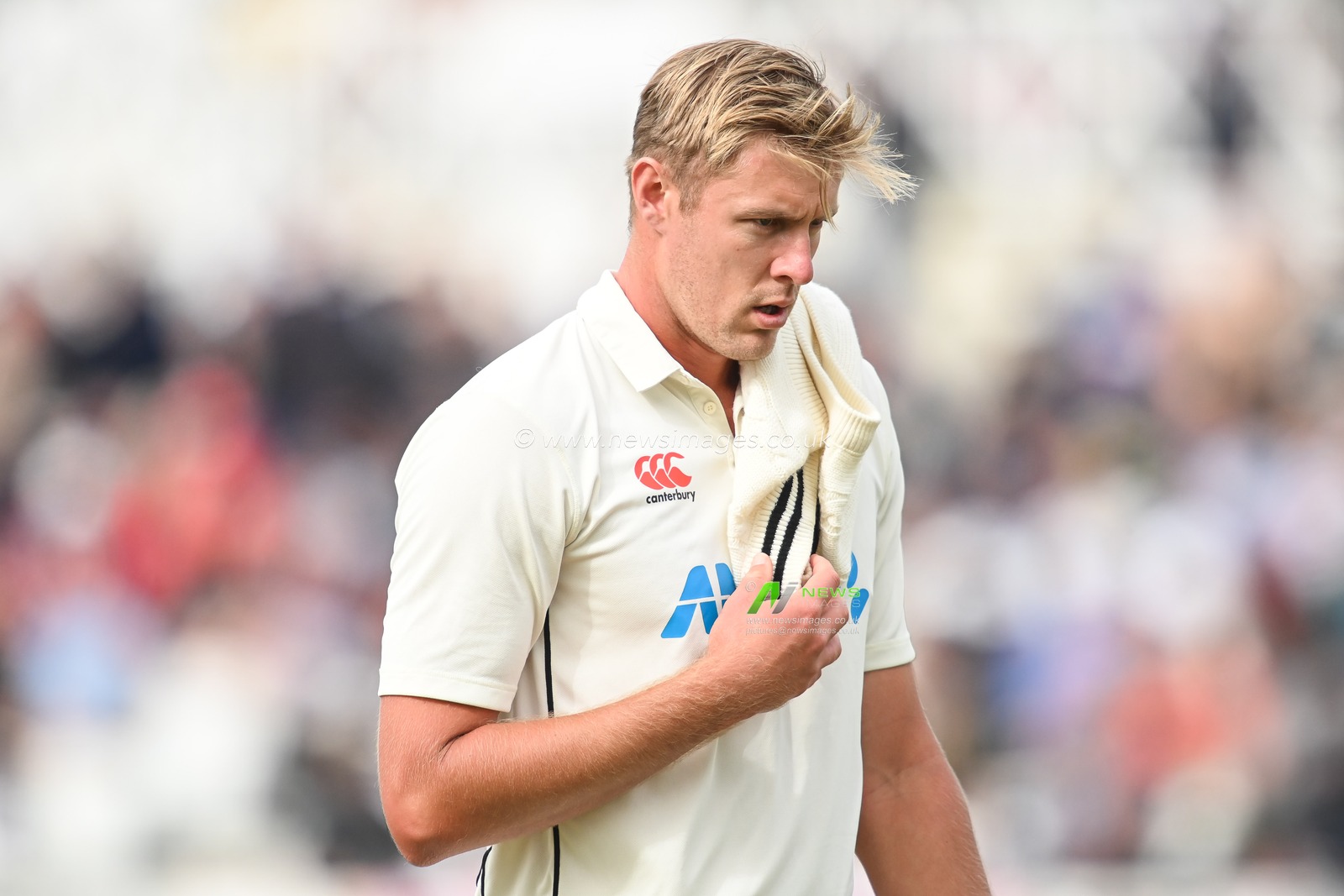 Kyle Jamieson of New Zealand leaves the field due to an injury