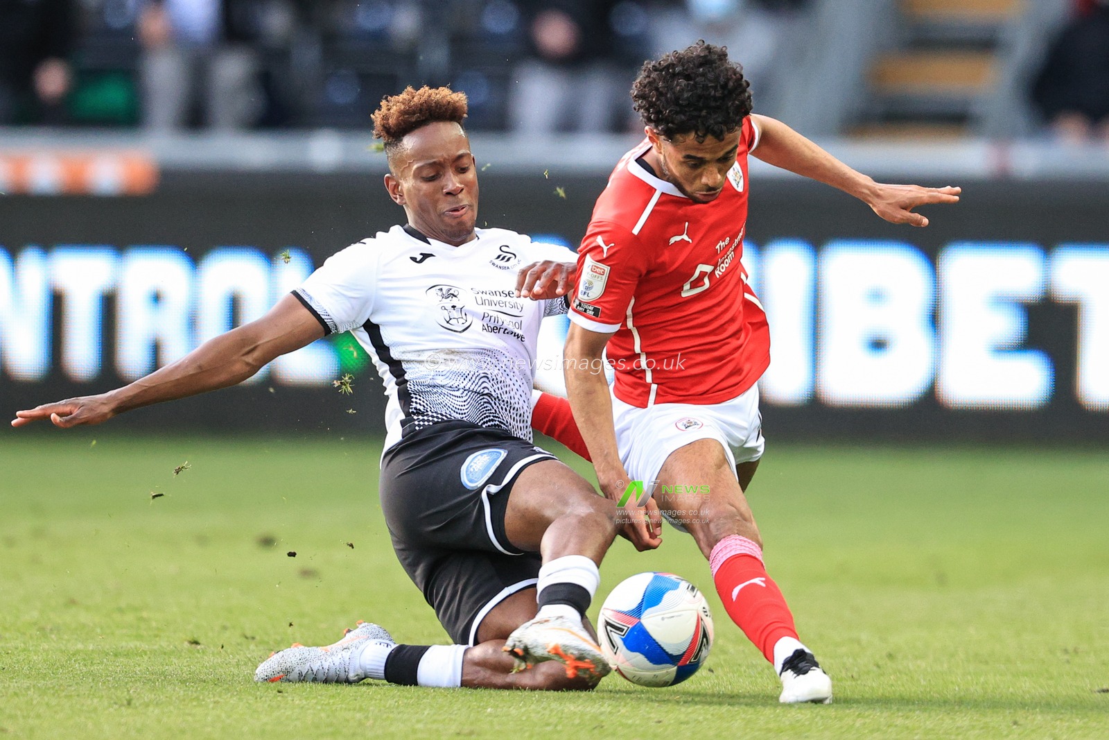 Romal Palmer #21 of Barnsley is fouled by Jamal Lowe #9 of Swansea City