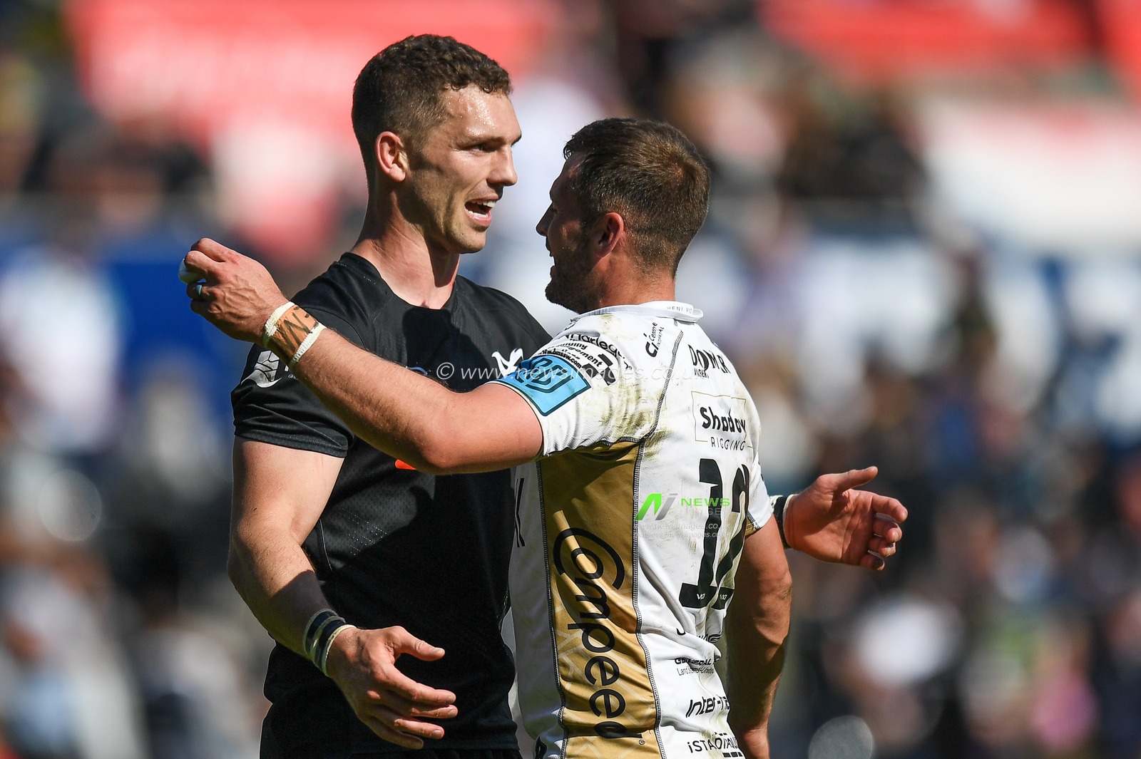 George North of Ospreys, and Josh Lewis of Dragons, embrace following the final whistle