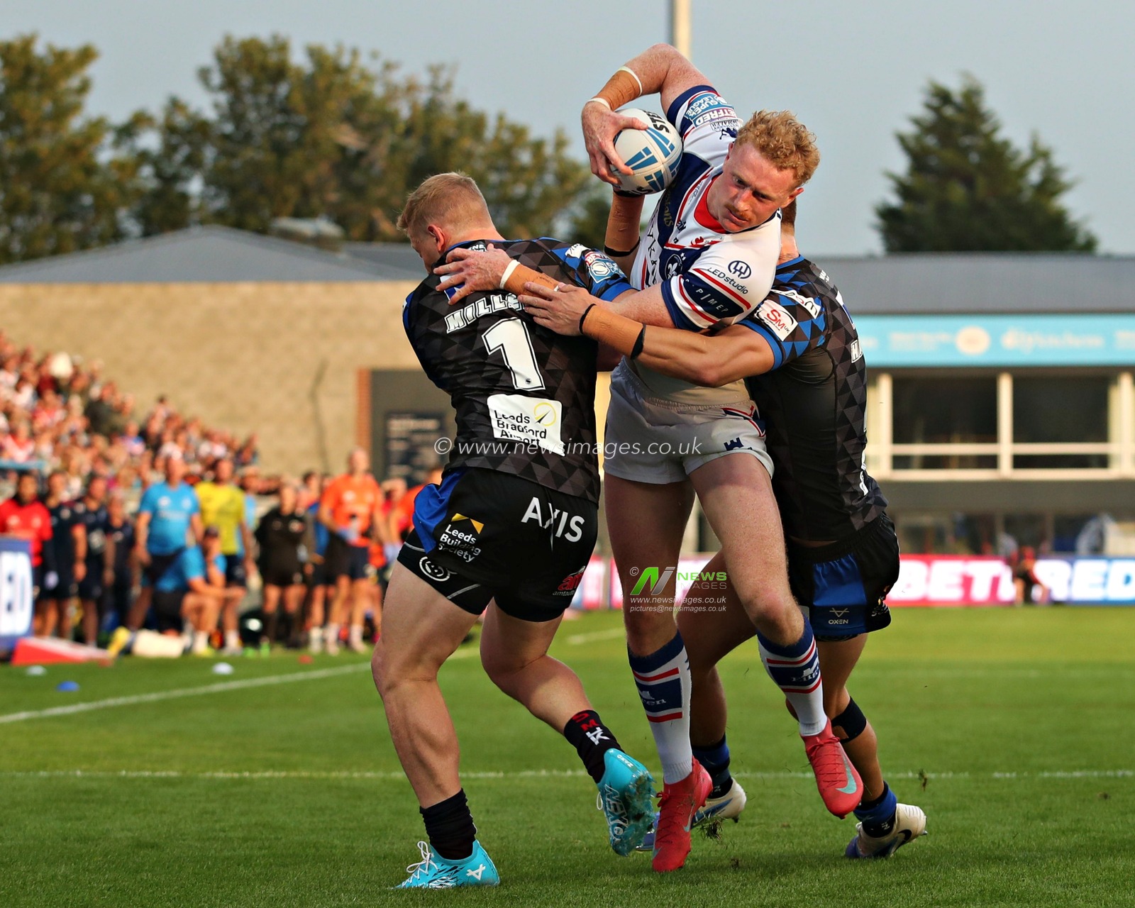 Lachlan Walmsley of Wakefield Trinity runs at Lachie Miller of Leeds Rhinos during the Betfred Super League round 20 match Wakefield Trinity vs Leeds Rhinos at DIY Kitchens Stadium, Wakefield, United Kingdom, 24th July 2025(Photo by Sam Eaden/News Images)