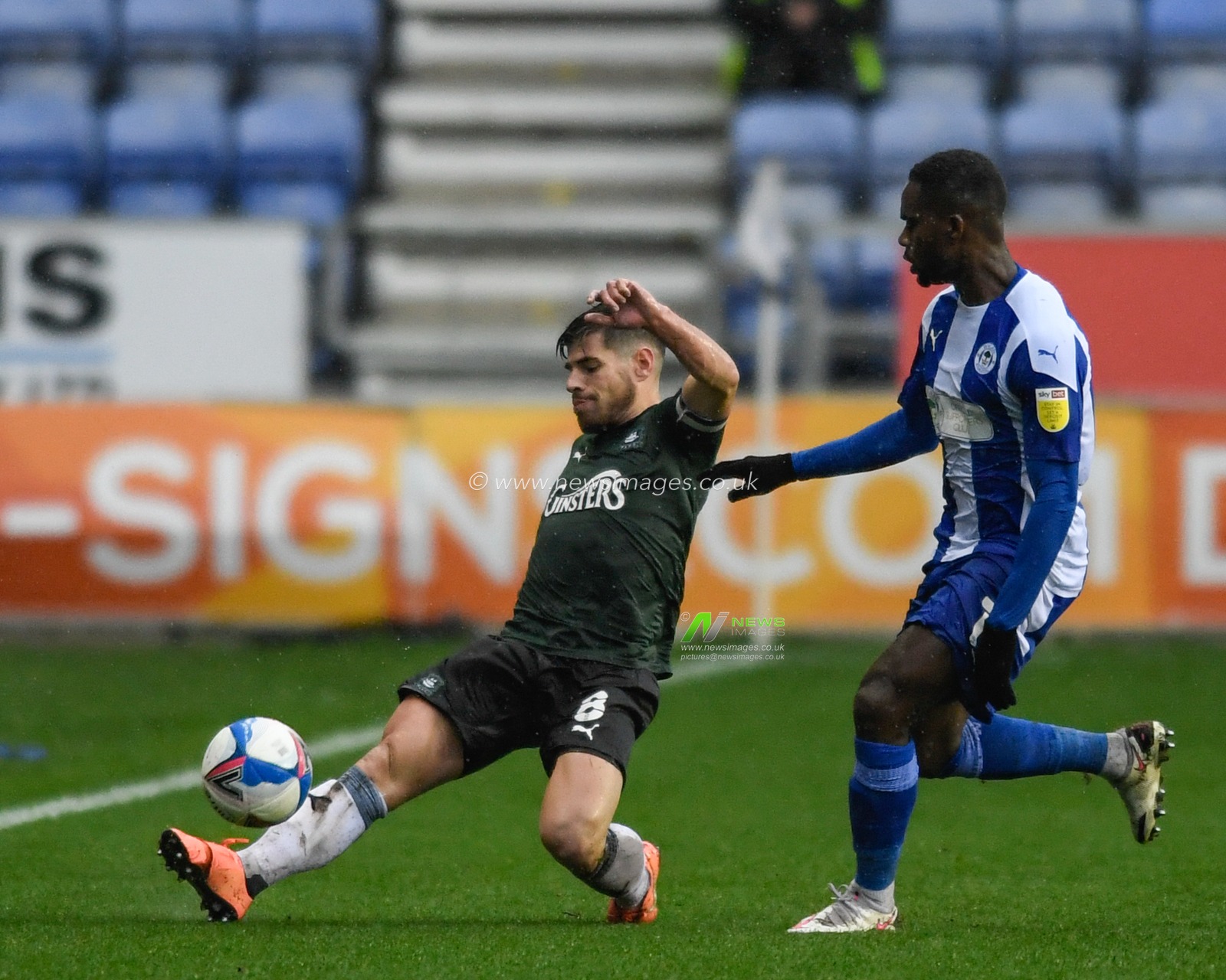 Joe Edwards (8) of Plymouth Argyle clears the ball