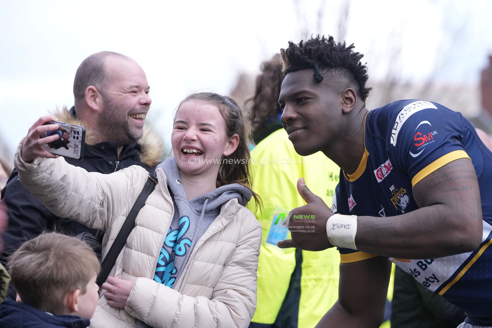 Justin Sangare #17 of Leeds Rhinos poses for a selfie with a fan after the Betfred Super League Round 6 match Leeds Rhinos vs Catalans Dragons at Headingley Stadium, Leeds, United Kingdom, 25th March 2023

(Photo by Steve Flynn/News Images)