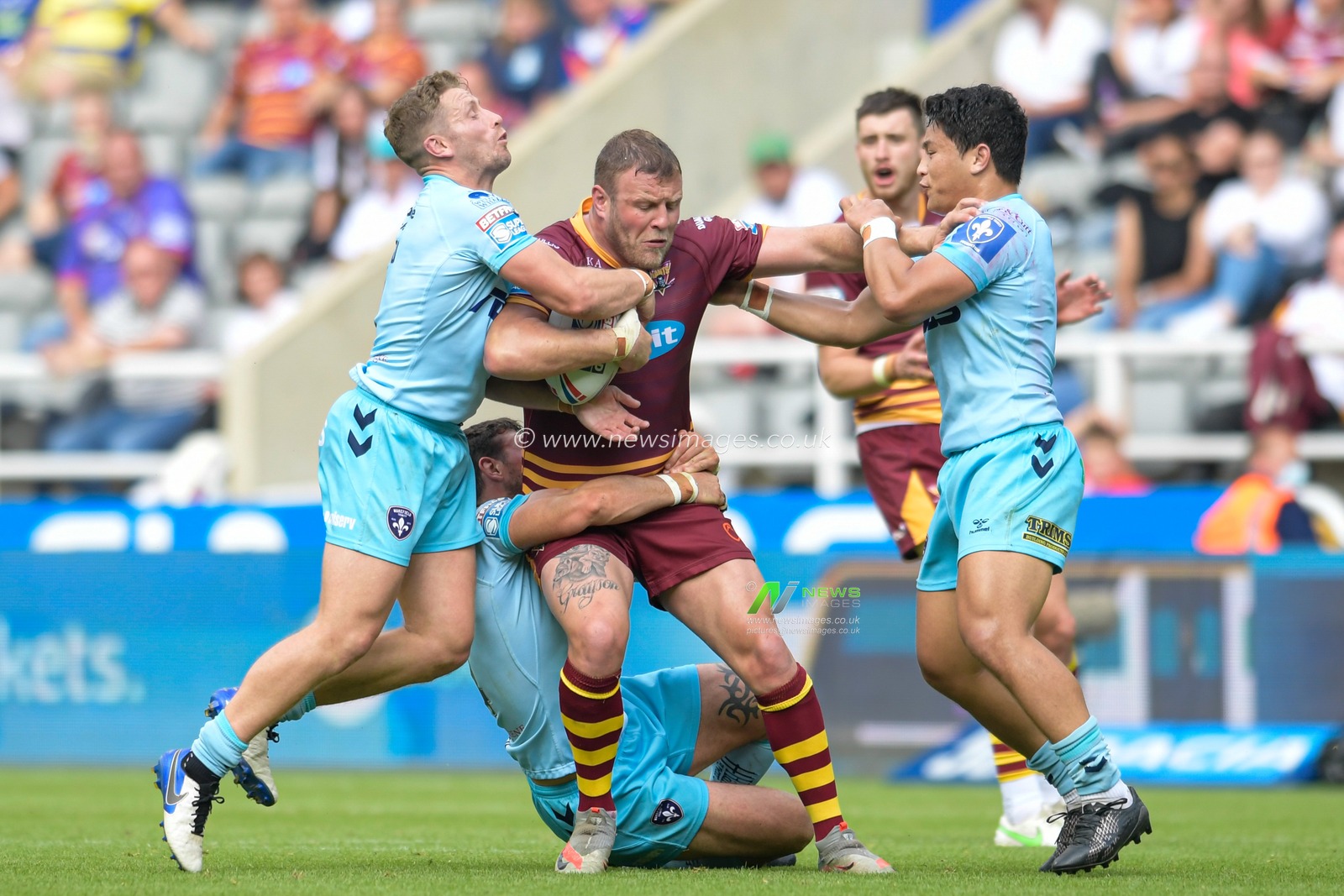 Josh Jones (13) of Huddersfield Giants runs the ball up the pitch