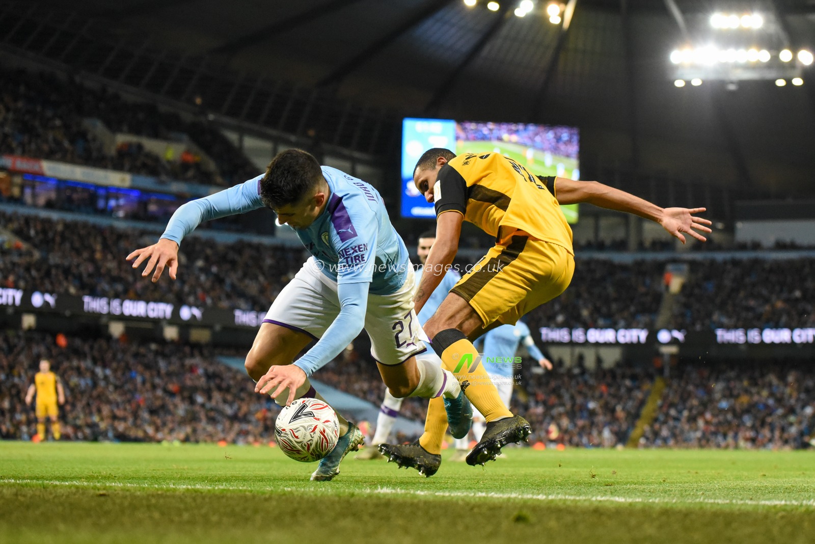 4th January 2020, Etihad Stadium, Manchester, England; Emirates FA Cup, Manchester City v Port Vale : Joao Cancelo (27) of Manchester City is fouled by Cristian Montano (11) of Port Vale

Credit: Simon Whitehead/News Images