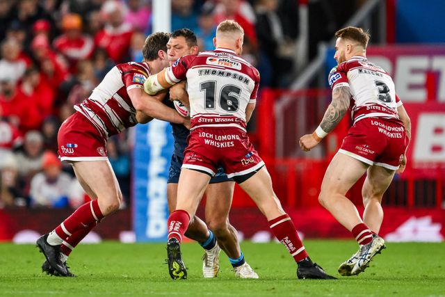 Ryan Hall of Hull KR is tackled by Ethan Havard and Luke Thompson of Wigan Warriors during the Betfred Super League Grand Final match Wigan Warriors vs Hull KR at Old Trafford, Manchester, United Kingdom, 12th October 2024

(Photo by Craig Thomas/News Images)