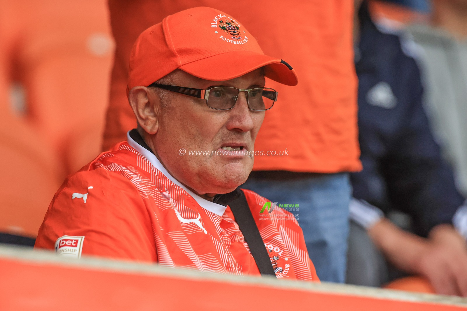 A fan watches Blackpool players warmup