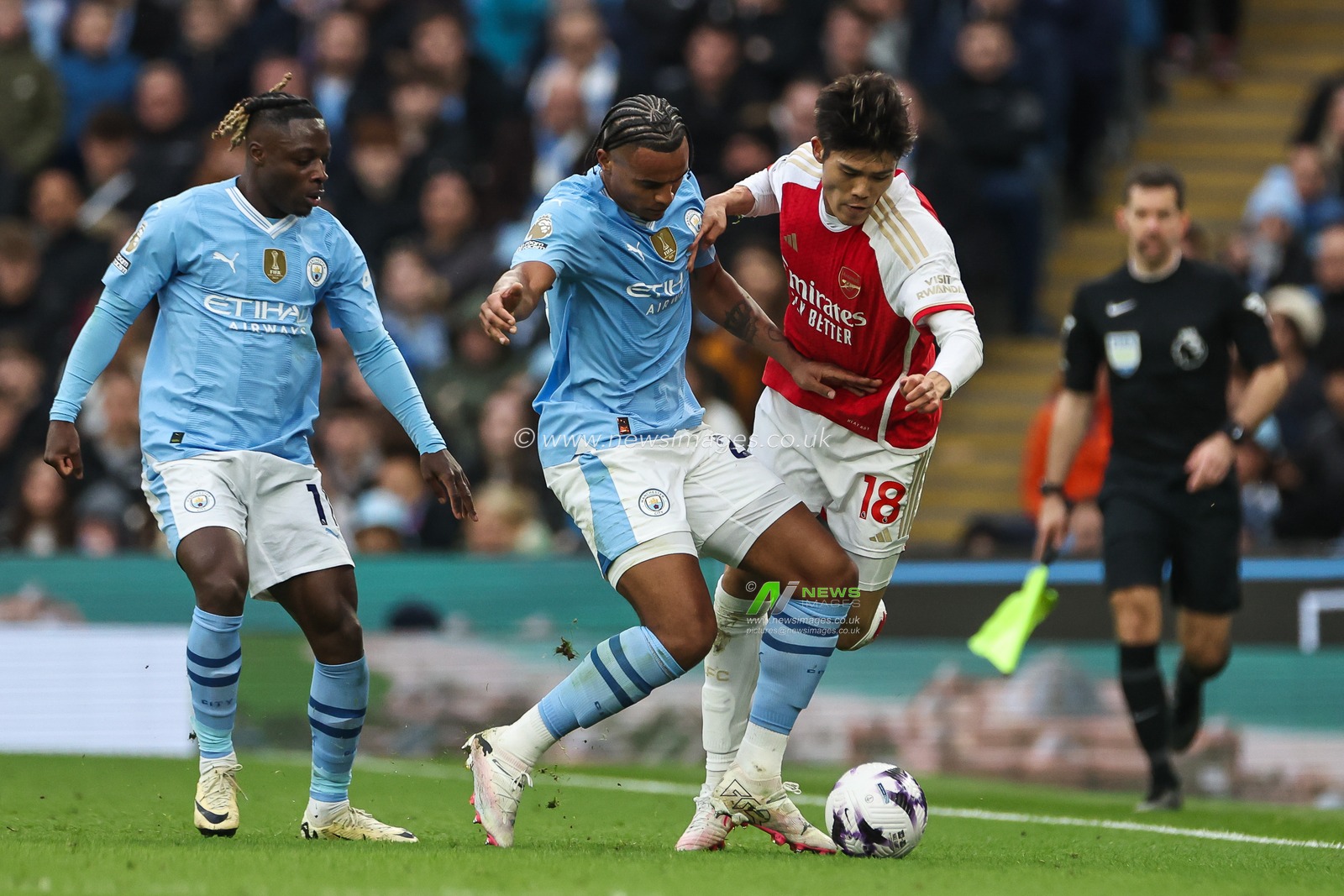 Takehiro Tomiyasu of Arsenal is tackled by Manuel Akanji of Manchester City during the Premier League match Manchester City vs Arsenal at Etihad Stadium, Manchester, United Kingdom, 31st March 2024

(Photo by Mark Cosgrove/News Images)