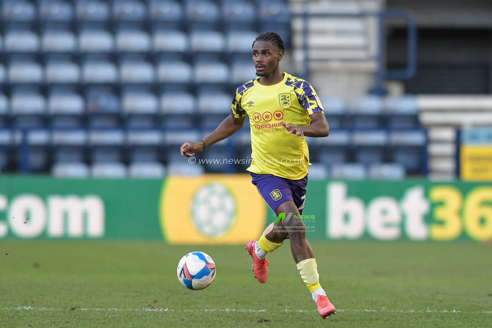 Aaron Rowe #29 of Huddersfield Town runs with the ball