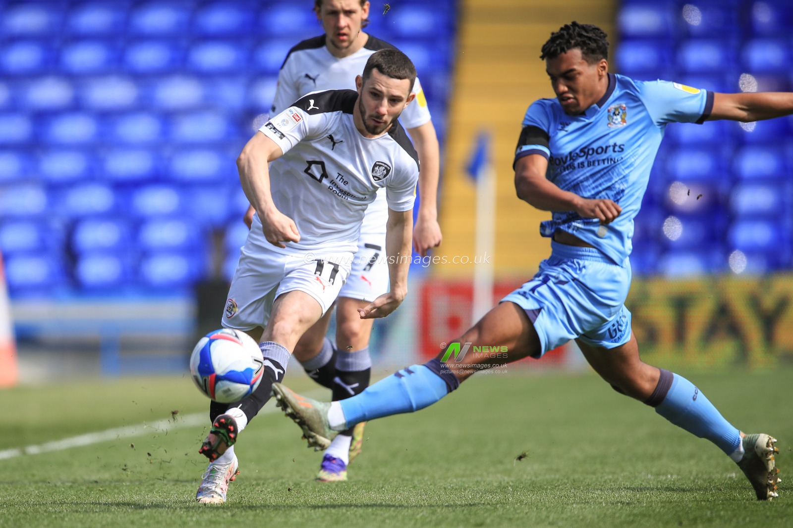 Conor Chaplin #11 of Barnsley passes the ball as Sam McCallum #21 of Coventry City challenges