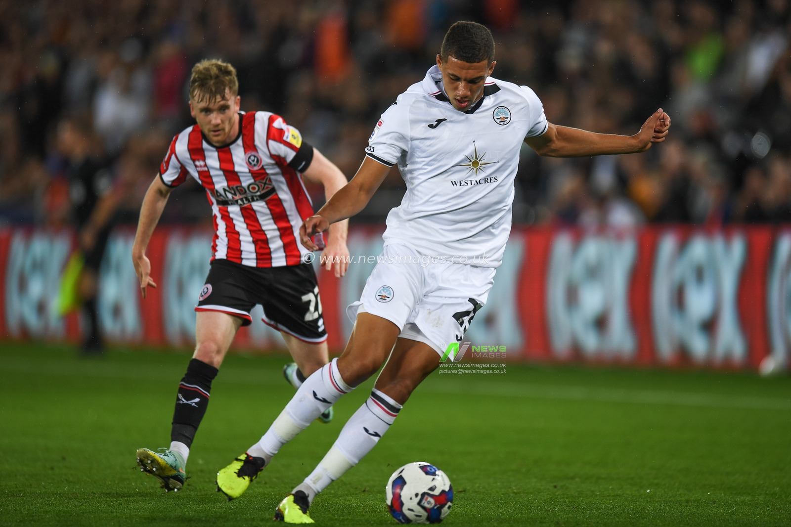Nathan Wood #23 of Swansea City Under pressure from Tommy Doyle #22 of Sheffield United during the Sky Bet Championship match Swansea City vs Sheffield United at Swansea.com Stadium, Swansea, United Kingdom, 13th September 2022

(Photo by Mike Jones/News Images)