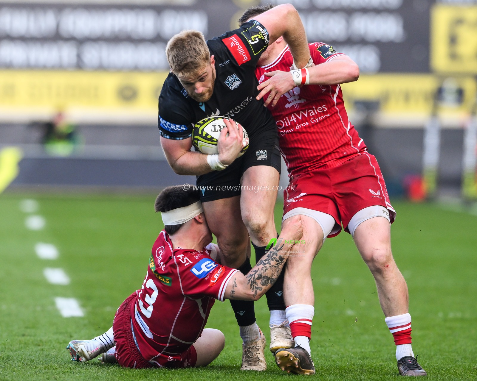 Kyle Steyn of Glasgow Warriors is tackled by Steff Evans and Joe Roberts of Scarlets during the European Challenge Cup Semi-Final match Llanelli Scarlets vs Glasgow Warriors at Parc y Scarlets, Llanelli, United Kingdom, 29th April 2023

(Photo by Craig Thomas/News Images)