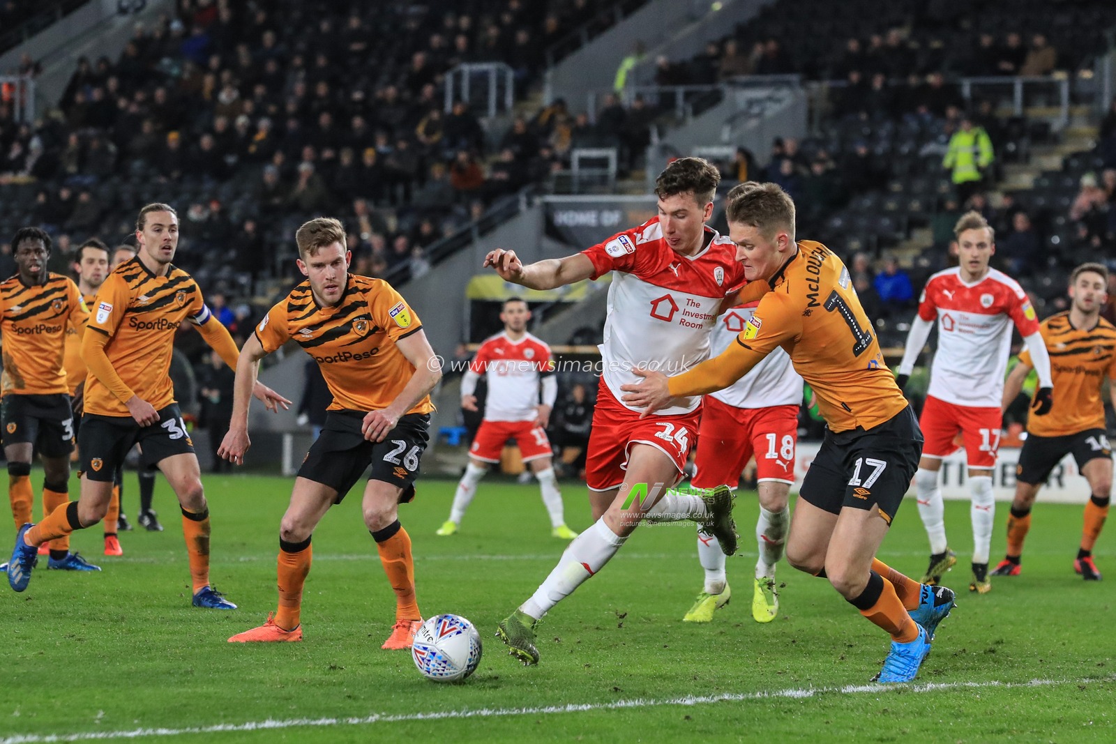 26th February 2020, KC Stadium, Kingston upon Hull, England; Sky Bet Championship, Hull City v Barnsley : Aapo Halme (24) of Barnsley attempts a shot on goal while under pressure from Sean McLoughlin (17) of Hull City