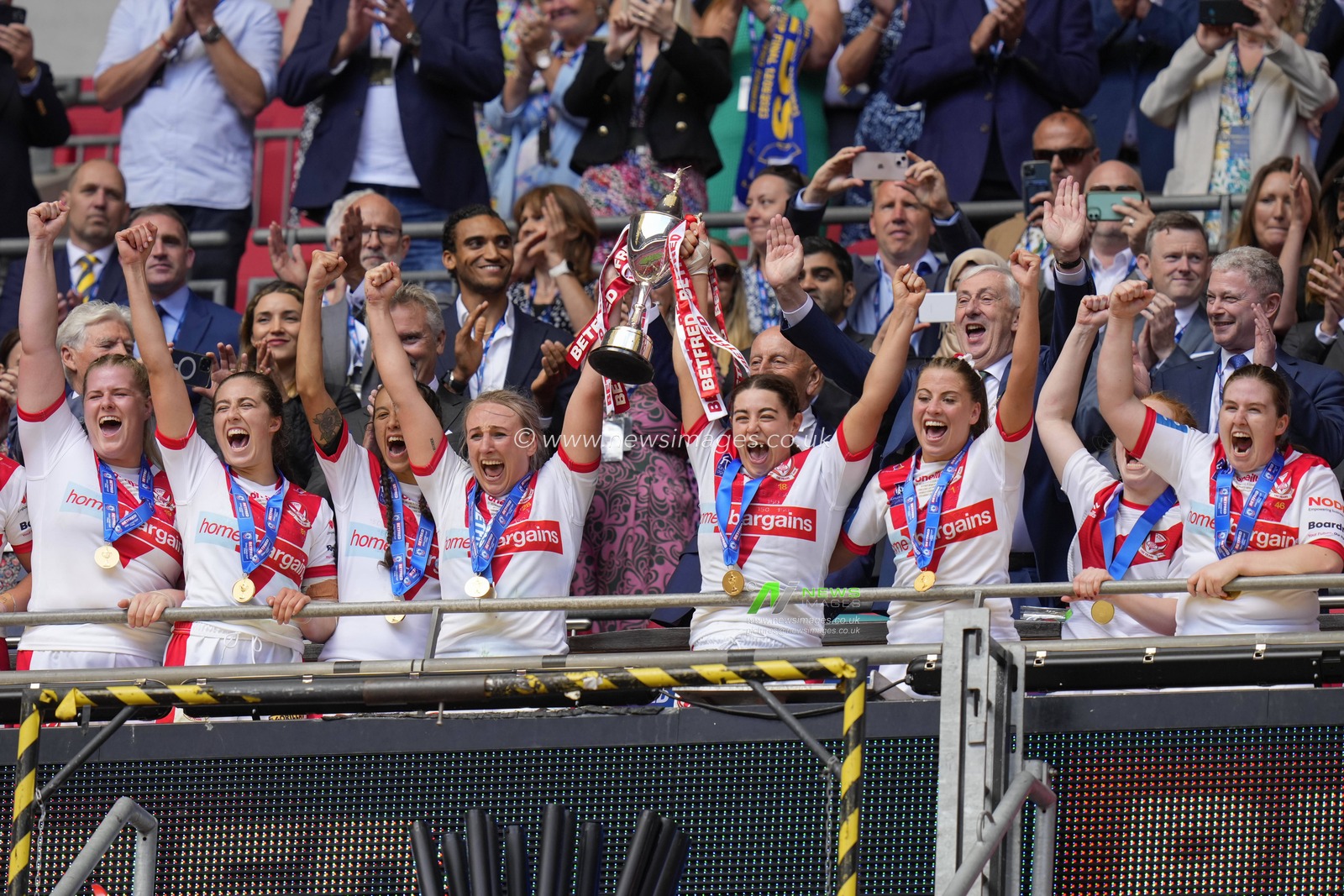 Jodie Cunningham #13 and Emily Rudge #12 of St. Helens lift the BetFred Women's Challenge Cup trophy after the Betfred Womens Challenge Cup Final match Leeds Rhinos vs St Helens at Wembley Stadium, London, United Kingdom, 12th August 2023

(Photo by Steve Flynn/News Images)