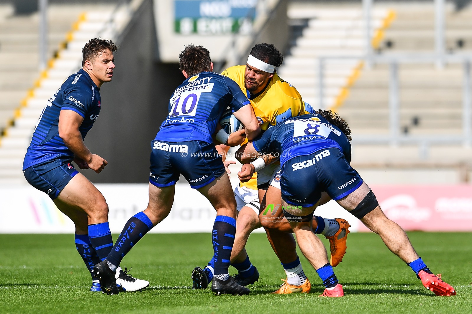 Josh Matavesi of Bath is tackled by AJ MacGinty of Sale Sharks