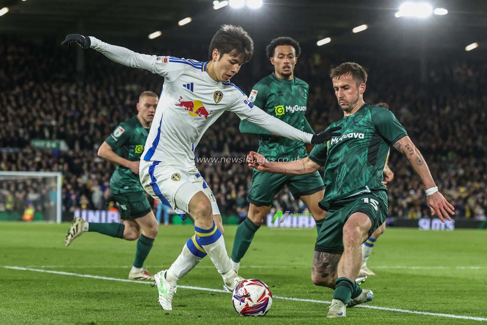 Ao Tanaka of Leeds United and Joe Bryan of Millwall battle for the ball during the Sky Bet Championship match Leeds United vs Millwall at Elland Road, Leeds, United Kingdom, 12th March 2025

(Photo by Alfie Cosgrove/News Images)