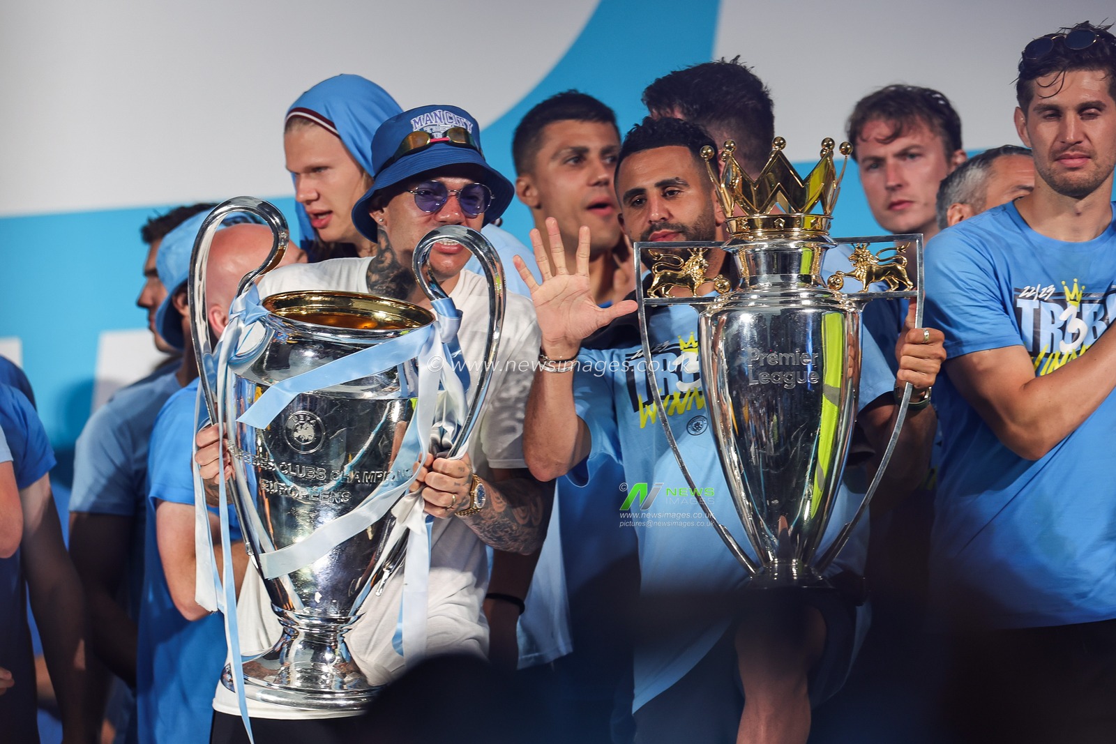 Riyad Mahrez #26 of Manchester City and Ederson #31 of Manchester City lifts the Champions league Trophy and Premier league Trophy on stage during Manchester City's Treble victory parade at St Peterâ€™s Square, Manchester, United Kingdom, 12th June 2023

(Photo by Mark Cosgrove/News Images)