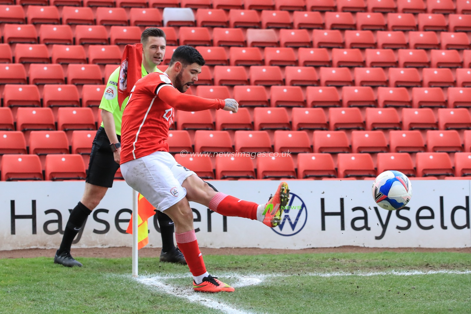 Alex Mowatt #27 of Barnsley  takes a corner